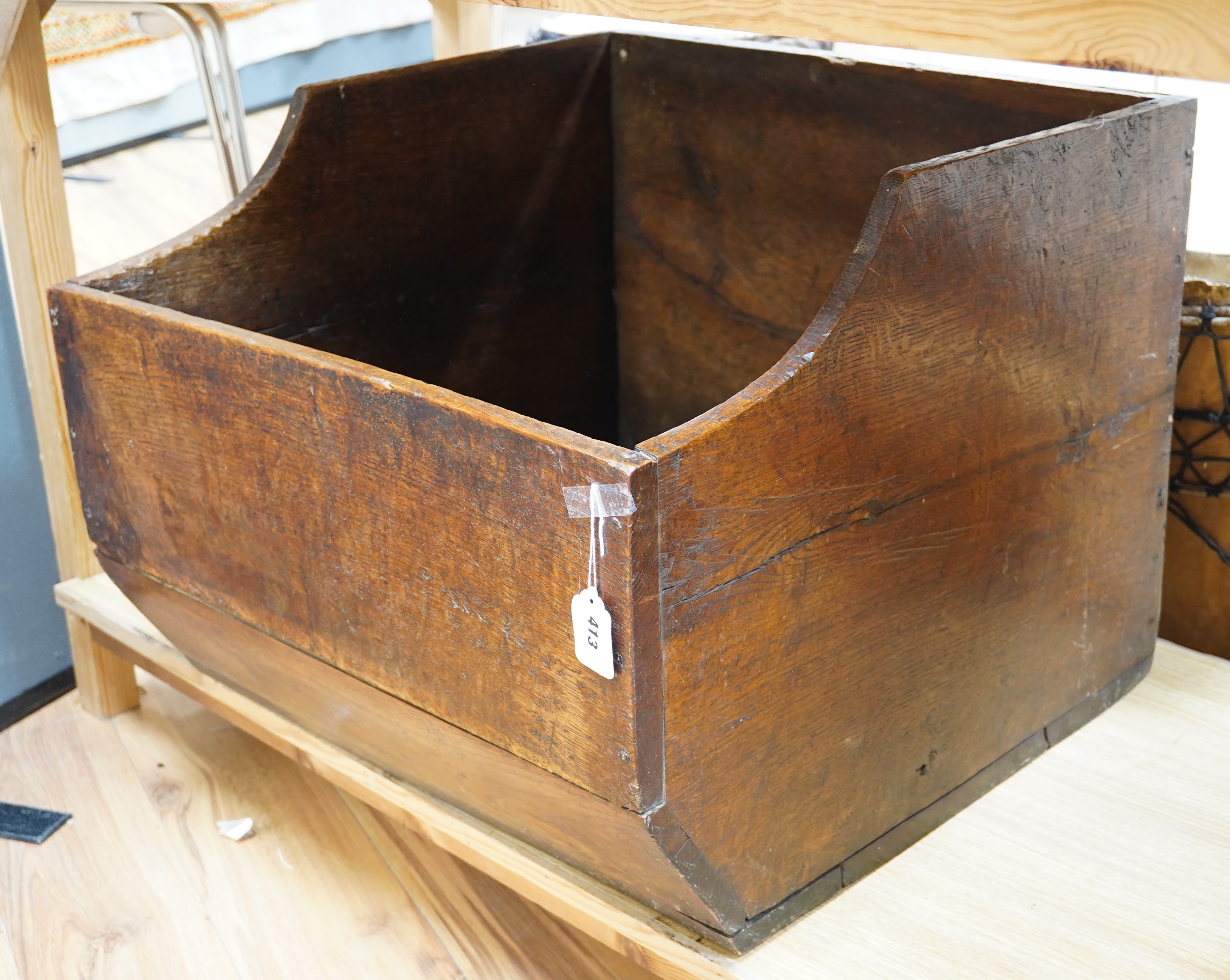 An early 20th century oak dog basket, 65cm wide. Condition - fair